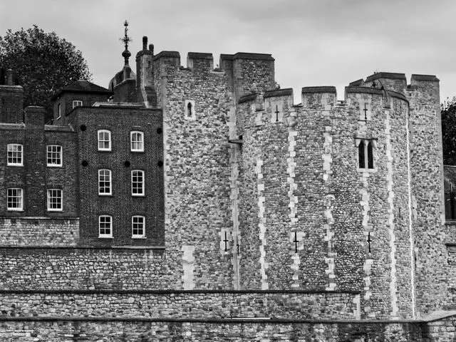 Black and white view of the White Tower inside the Tower of London fortress.