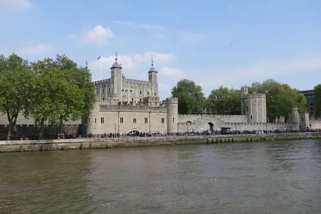 Tower of London viewed from the River Thames on a bright day in London.