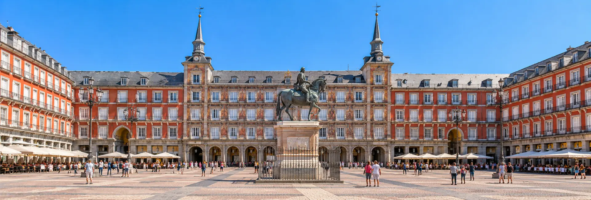 Plaza Mayor in Madrid with historic red façades and the central equestrian statue