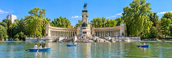 Retiro Park in Madrid with its grand lake, rowboats, and Alfonso XII monument