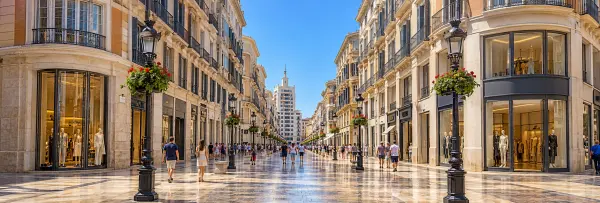 Calle Marqués de Larios in Málaga with elegant buildings, shops and pedestrians.