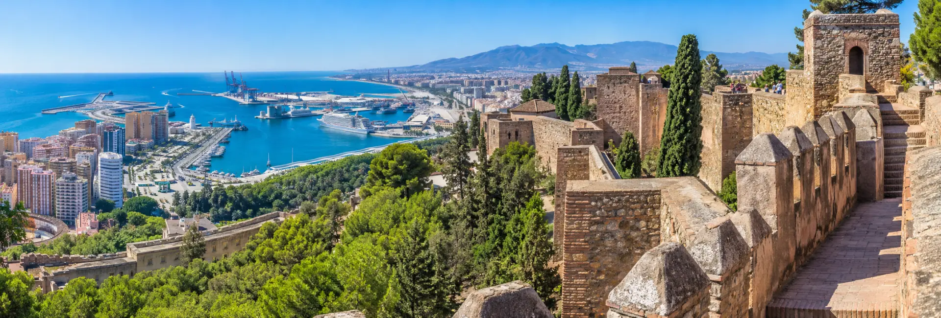 Castillo de Gibralfaro ramparts overlooking Málaga and the Mediterranean coast.