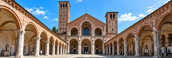 Basilica di Sant’Ambrogio in Milan with its historic Romanesque façade, bell towers and arched courtyard.