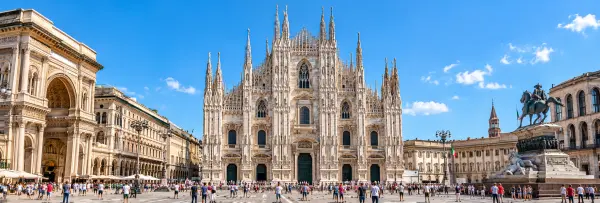 Duomo di Milano cathedral in Piazza del Duomo under a bright blue sky