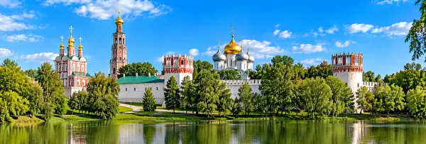 Novodevichy Convent in Moscow with white walls, ornate towers and golden domes