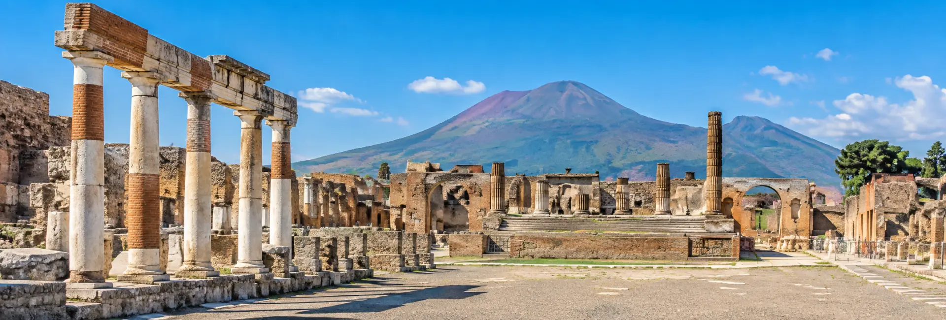 Pompeii Archaeological Park ruins with Mount Vesuvius in the background