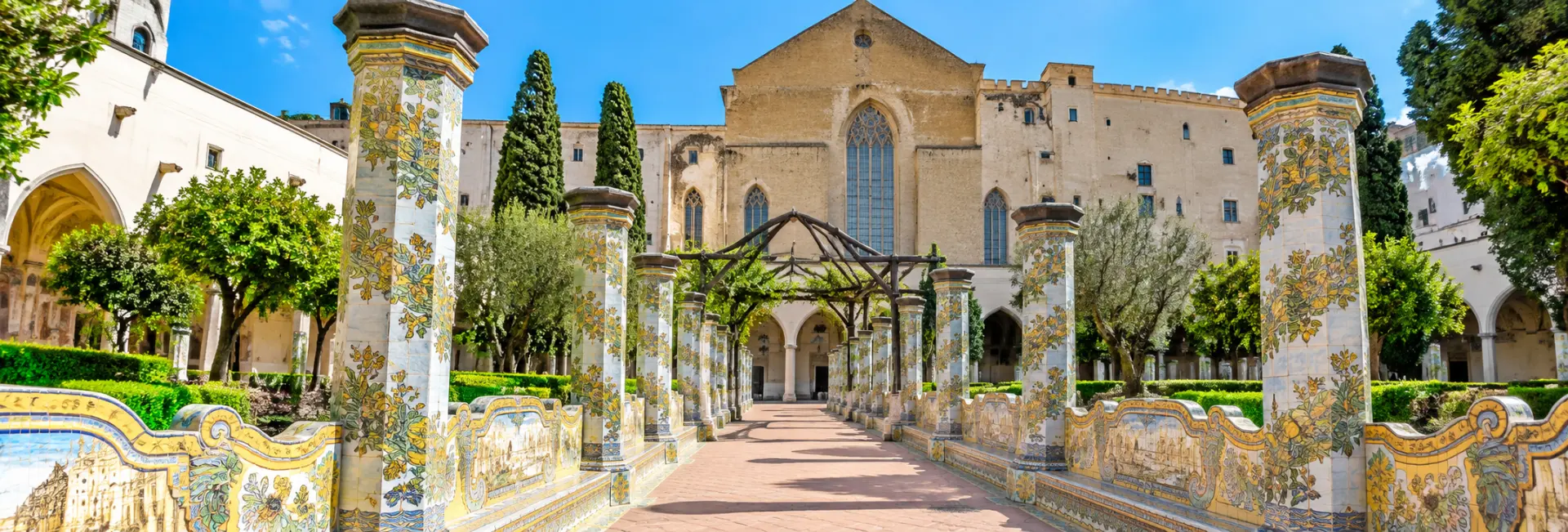 Santa Chiara in Naples, Italy, featuring its historic church and colorful majolica-tiled cloister