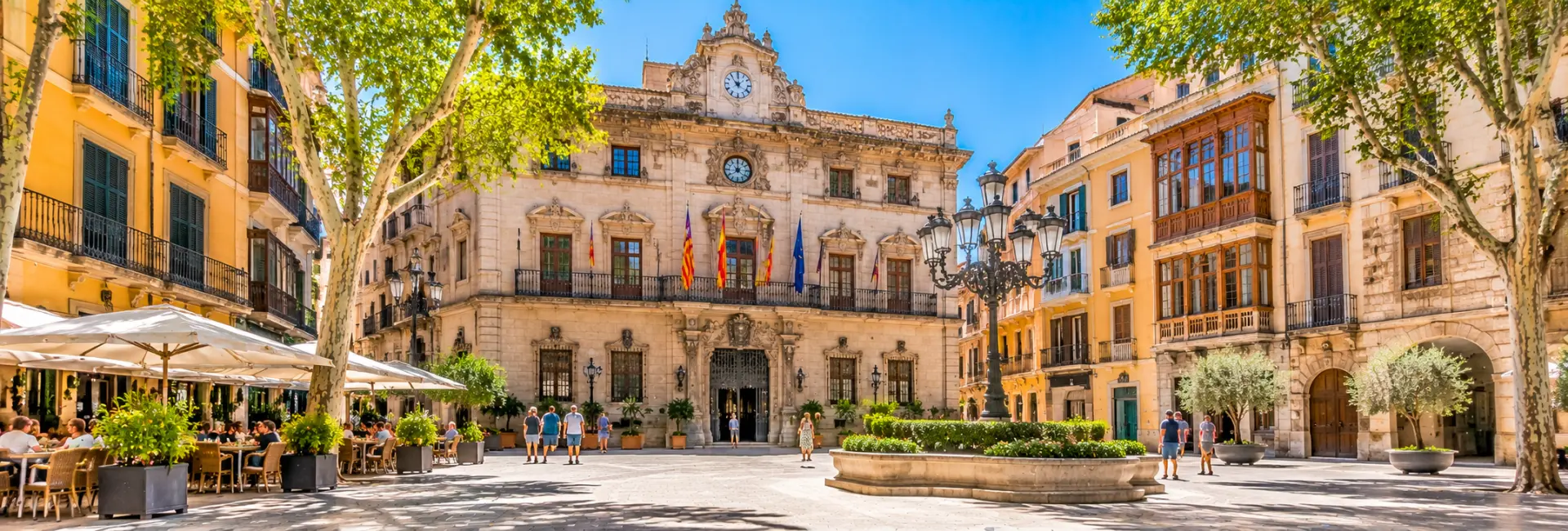Plaza de Cort in Palma de Mallorca, featuring the historic Town Hall, elegant architecture and outdoor cafés.