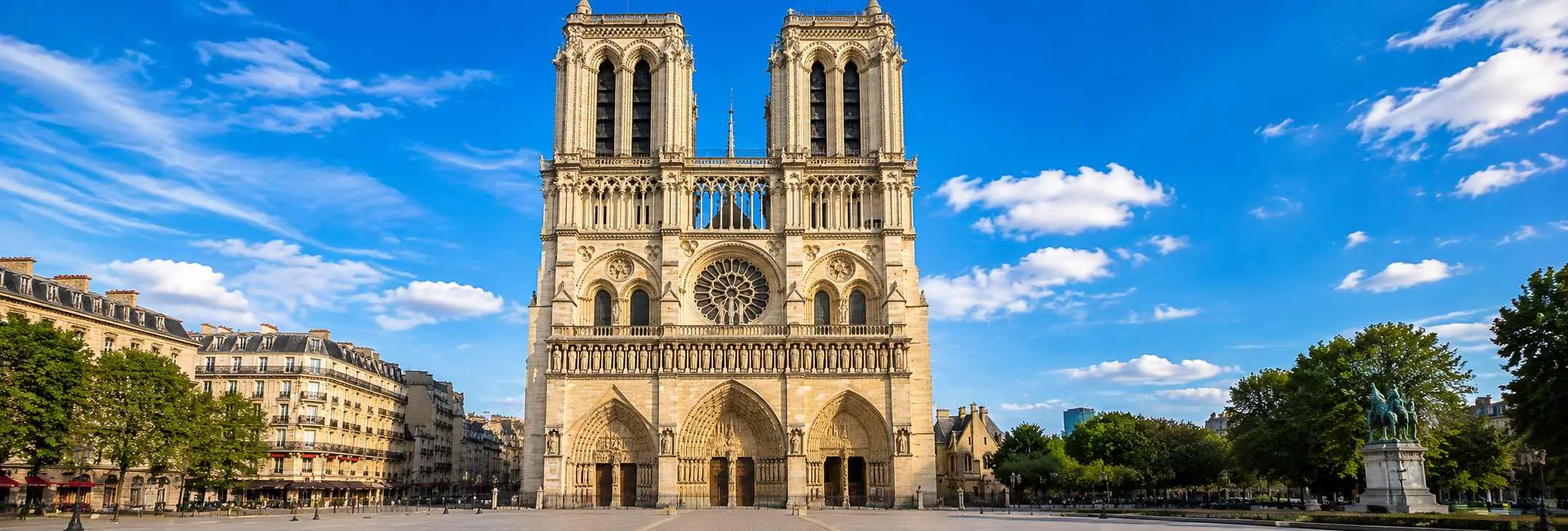 Front view of the restored Notre-Dame Cathedral in Paris on a bright sunny day, showcasing its iconic Gothic façade, twi
