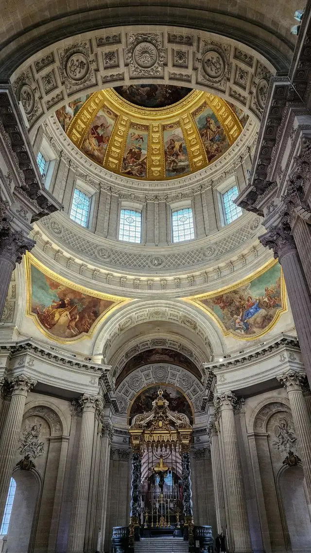 Interior of the Panthéon in Paris with its ornate dome, frescoes and golden details