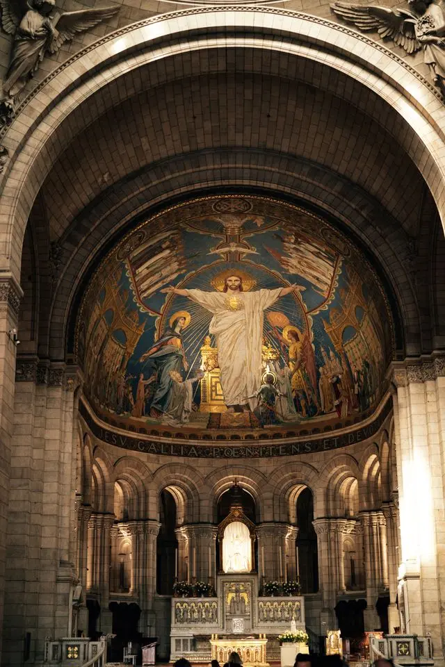 Interior of Sacré-Cœur Basilica featuring a large golden Christ mosaic
