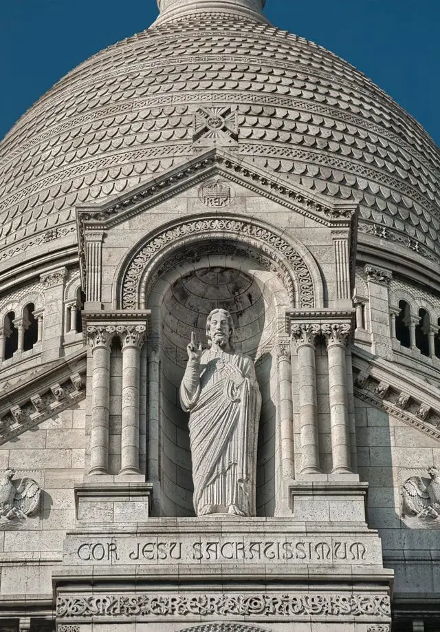 Close-up of Sacré-Cœur Basilica dome and Christ statue in Paris