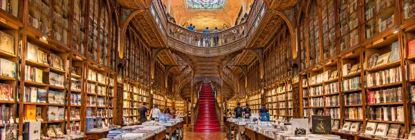 Livraria Lello in Porto, Portugal, featuring an ornate Gothic façade and colorful stained-glass details.
