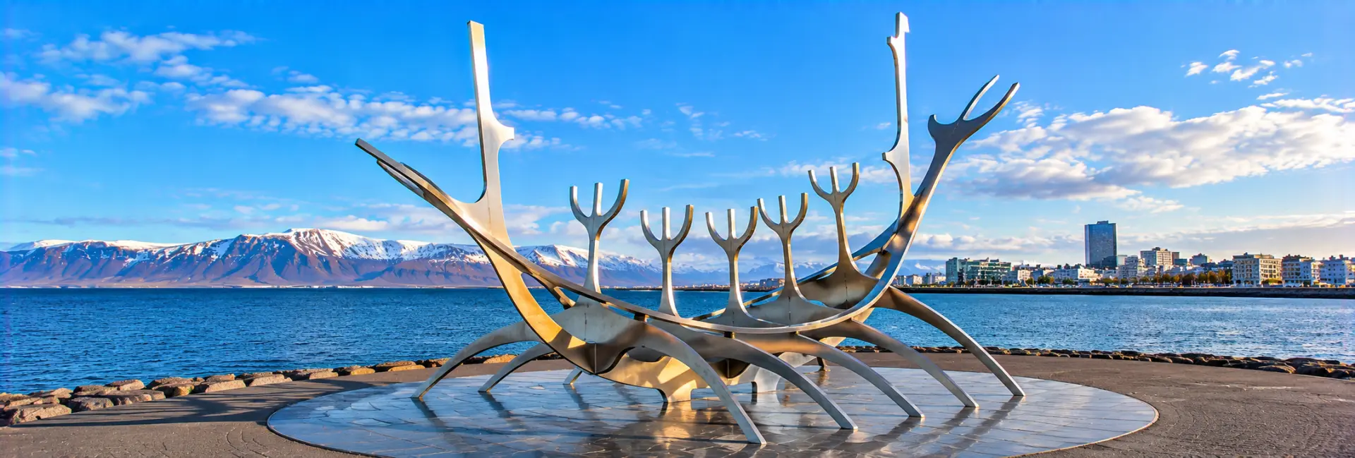 Sun Voyager sculpture on Reykjavík’s waterfront with mountains and sea in the background