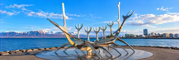 Sun Voyager sculpture on Reykjavík’s waterfront with mountains and sea in the background