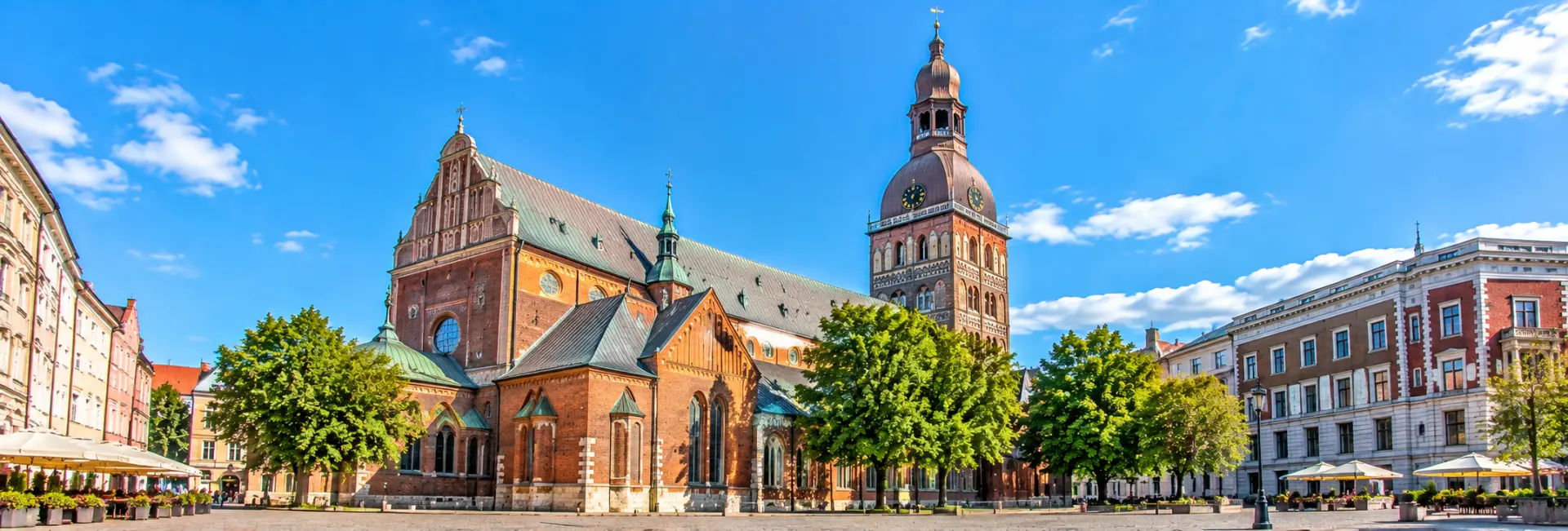 Riga Cathedral in Latvia, featuring historic red-brick architecture, a prominent bell tower and Dome Square.