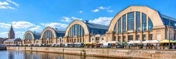 Riga Central Market in Latvia, featuring historic arched market halls, outdoor stalls and the waterfront.