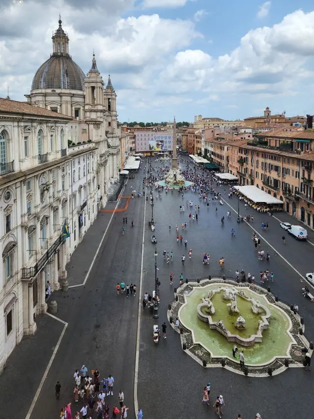 Panoramic view of Piazza Navona with fountains and historic buildings in Rome