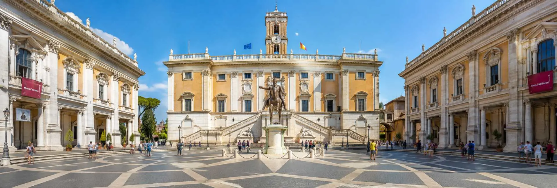 The Capitoline Museums surrounding Piazza del Campidoglio in Rome under a bright blue sky