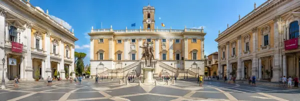 The Capitoline Museums surrounding Piazza del Campidoglio in Rome under a bright blue sky