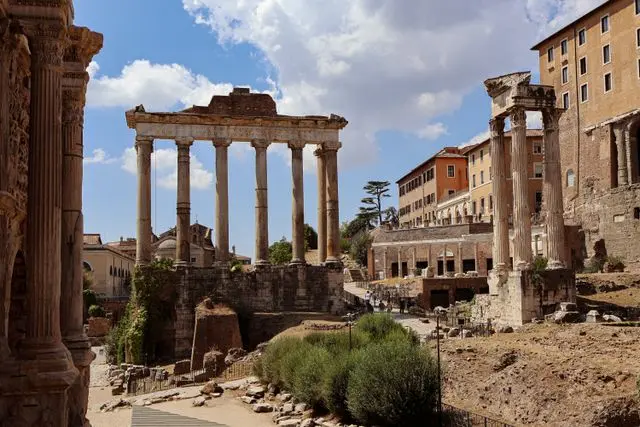 Ancient Roman Forum ruins with towering temple columns and historic buildings