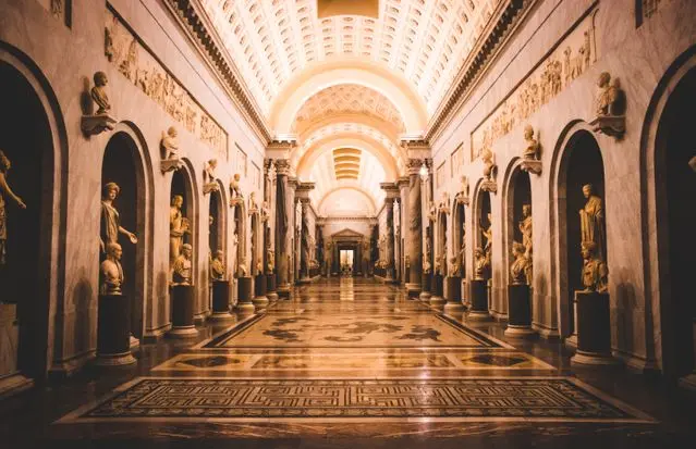Marble sculpture gallery inside the Vatican Museums with classical Roman statues.