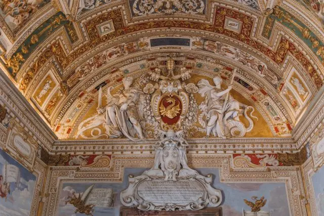 Ornate Renaissance ceiling and sculptures inside the Vatican Museums in Vatican City.