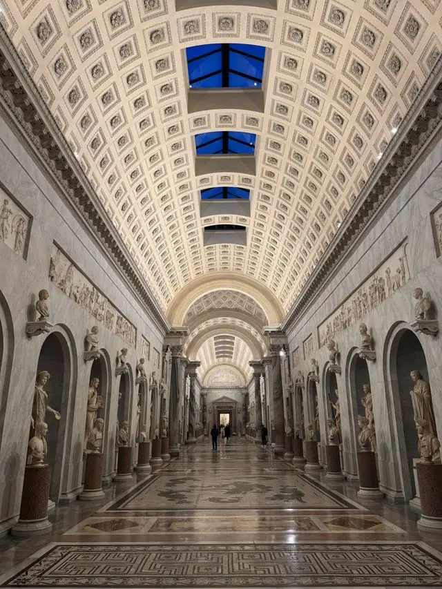 Bright marble corridor with statues inside the Vatican Museums in Vatican City.