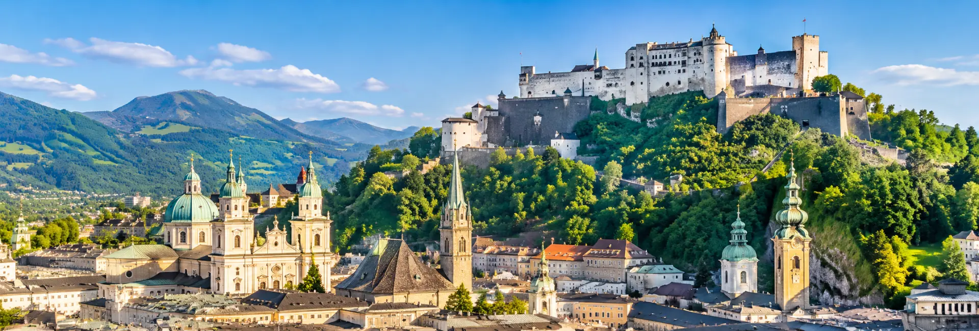 Hohensalzburg Fortress overlooking Salzburg’s historic cityscape and surrounding Austrian Alps.