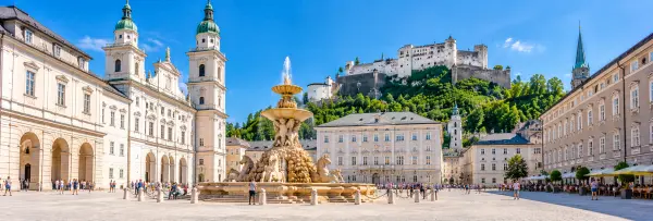 Residenzplatz in Salzburg, Austria, with Residenz Fountain and historic Baroque architecture.