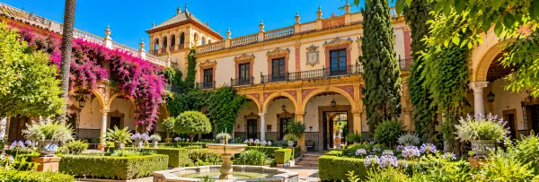 Palacio de las Dueñas in Seville, Spain, featuring an elegant historic courtyard and lush gardens.