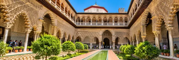 Royal Alcázar of Seville, Spain, showcasing its ornate Moorish arches and beautiful courtyard.