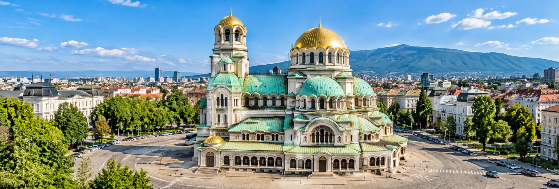 Panoramic view of Alexander Nevsky Cathedral in Sofia, Bulgaria, featuring golden domes and Neo-Byzantine architecture.
