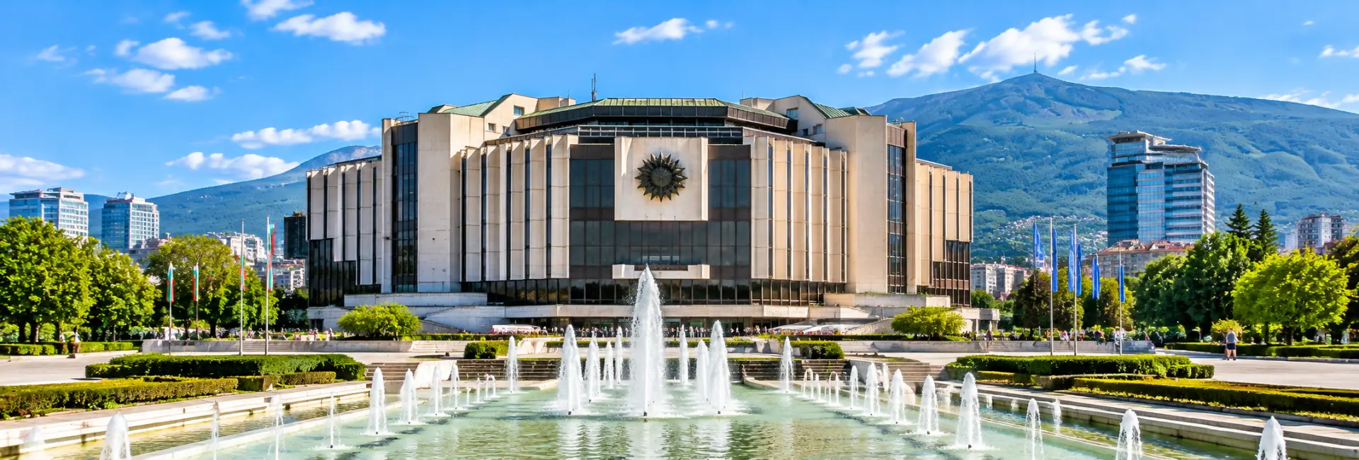 National Palace of Culture in Sofia, Bulgaria, featuring modern architecture, fountains and Vitosha Mountain.