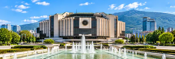 National Palace of Culture in Sofia, Bulgaria, featuring modern architecture, fountains and Vitosha Mountain.