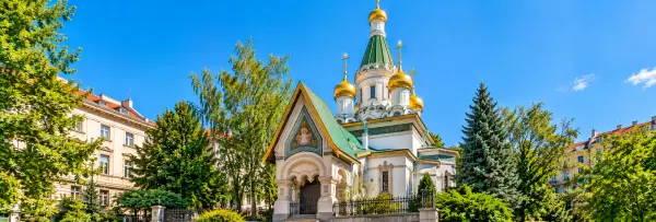 Russian Church of St. Nicholas in Sofia, Bulgaria, featuring golden onion domes, green roofs, and ornate architecture.