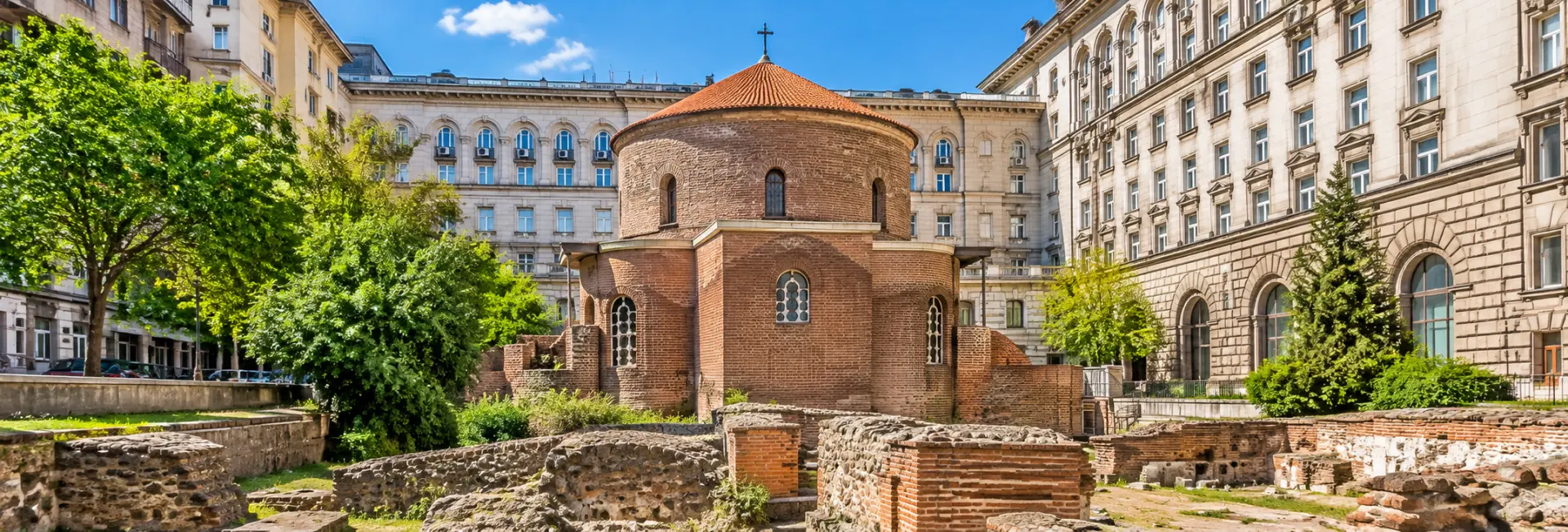 Saint George Rotunda in Sofia, Bulgaria, featuring ancient red-brick Roman architecture and surrounding ruins.