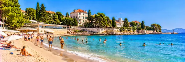 Bačvice Beach in Split, Croatia, with sandy shores, clear Adriatic waters and swimmers.