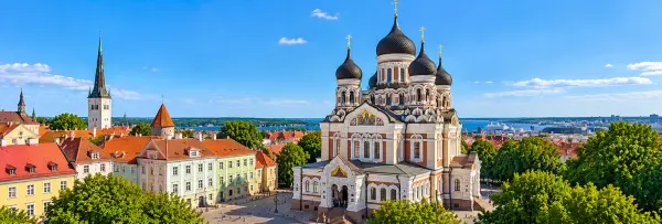Alexander Nevsky Cathedral in Tallinn, Estonia, featuring ornate architecture, black onion domes and golden crosses.