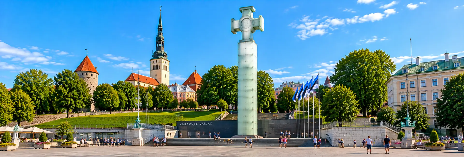 Freedom Square in Tallinn, Estonia, featuring the Cross of Liberty monument, Estonian flags and historic buildings.