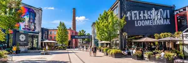 Telliskivi Creative City in Tallinn, Estonia, featuring colorful street art, industrial buildings and outdoor cafés.
