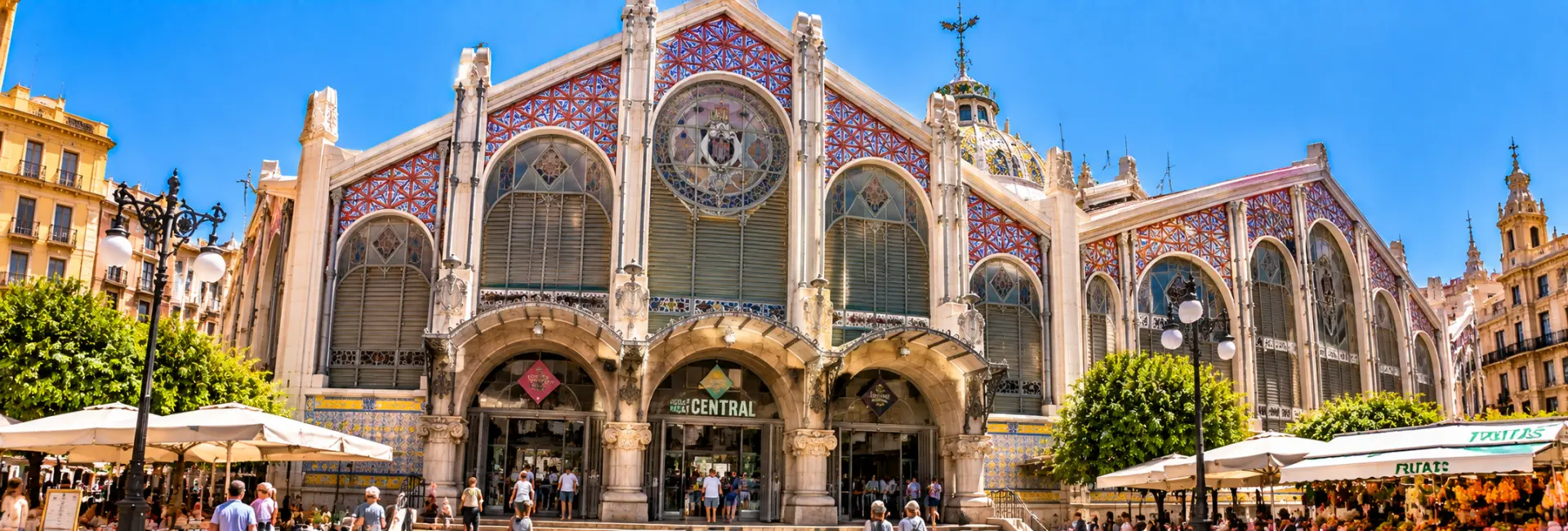 Central Market of Valencia, Spain, featuring ornate Modernista architecture and colorful tiled façades.