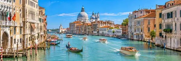 Grand Canal in Venice, Italy, with historic palaces, gondolas, boats, and Santa Maria della Salute.