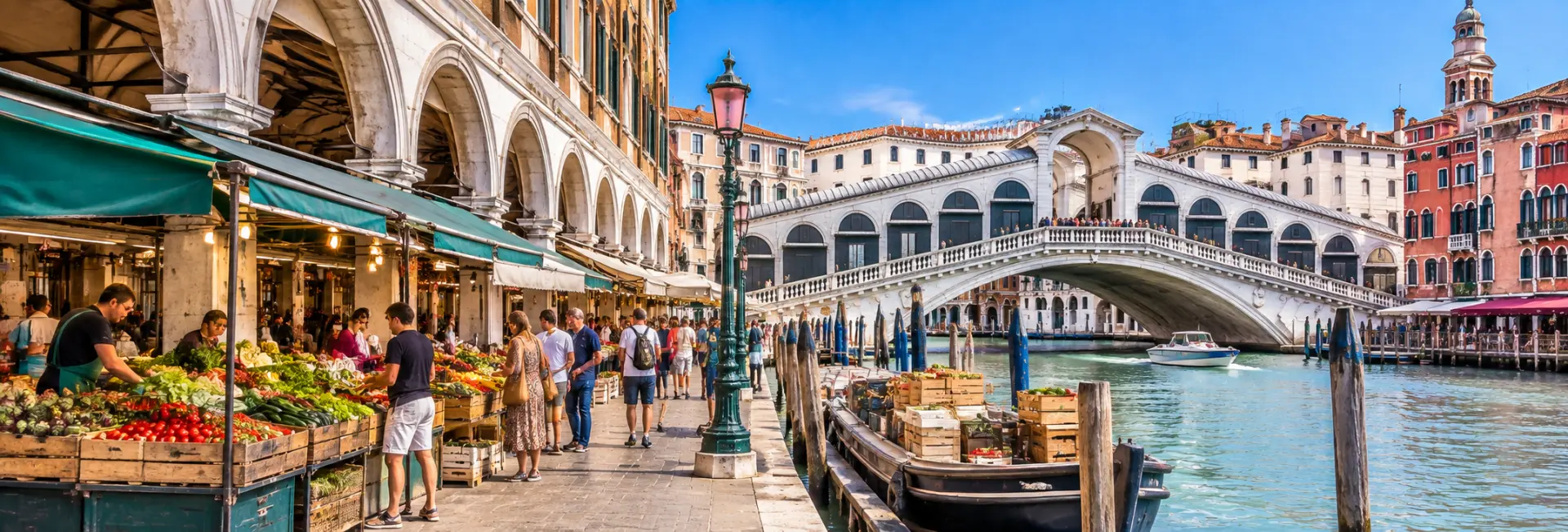 Rialto Market in Venice, Italy, with colorful market stalls, shoppers, canal boats, and the Rialto Bridge.