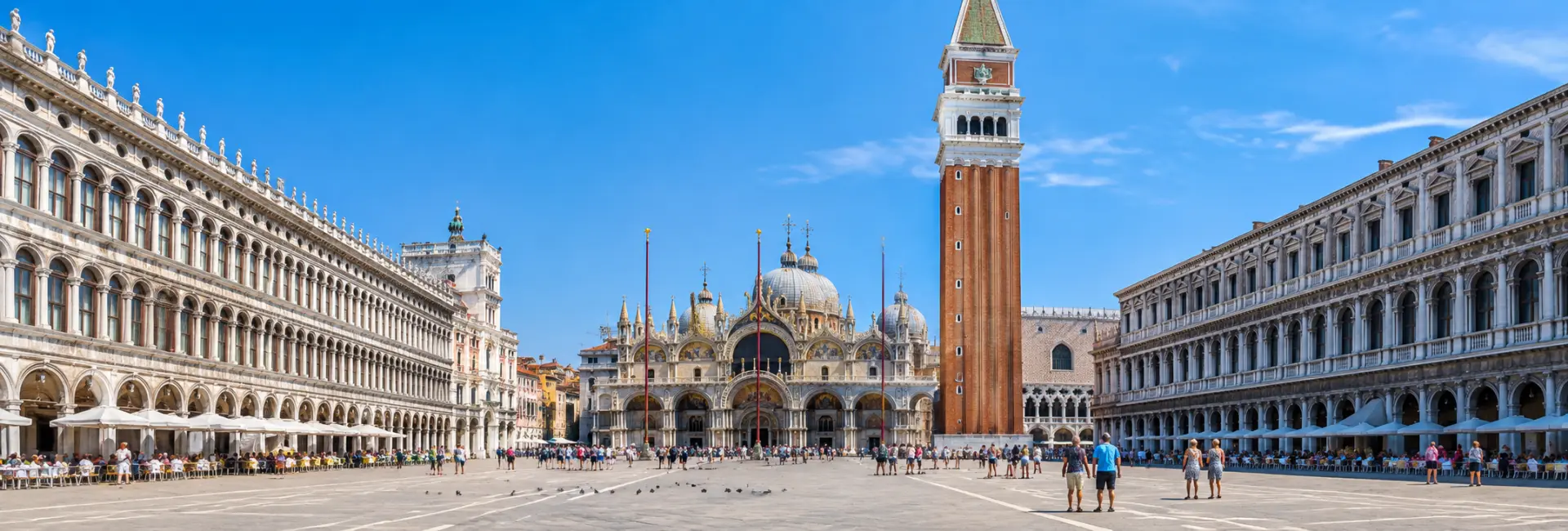 St. Mark’s Square in Venice with St. Mark’s Basilica and Campanile under a clear blue sky.