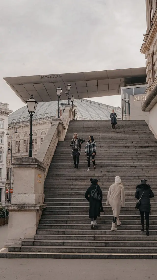 Visitors climbing the grand staircase to the Albertina Museum in Vienna