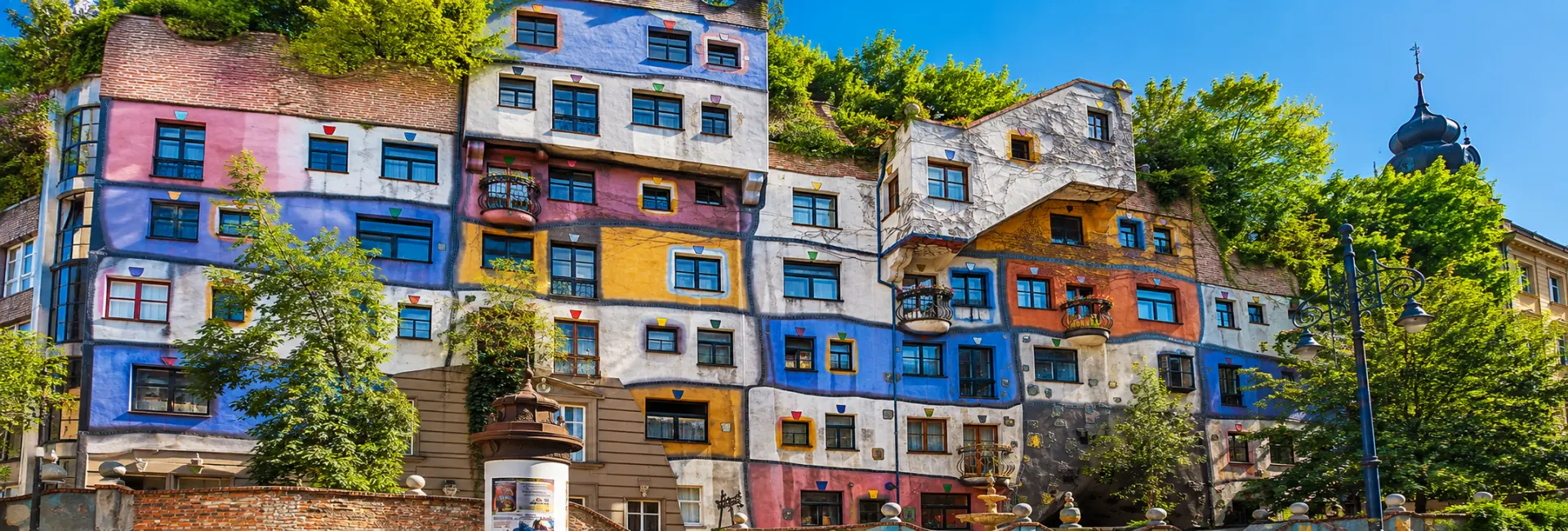 Hundertwasserhaus in Vienna with its colorful, irregular façade and lush greenery