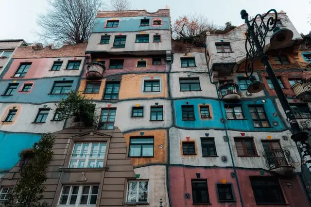Colorful Hundertwasserhaus façade in Vienna with irregular windows and distinctive balconies
