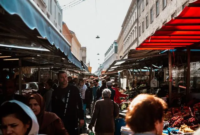 Crowded Naschmarkt in Vienna with food stalls and shoppers