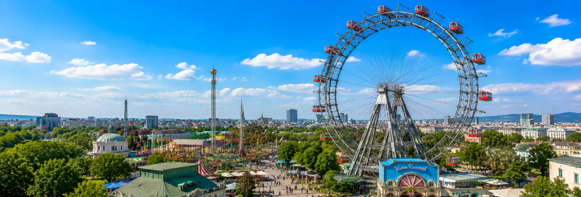 Prater amusement park in Vienna with the iconic Giant Ferris Wheel and city skyline